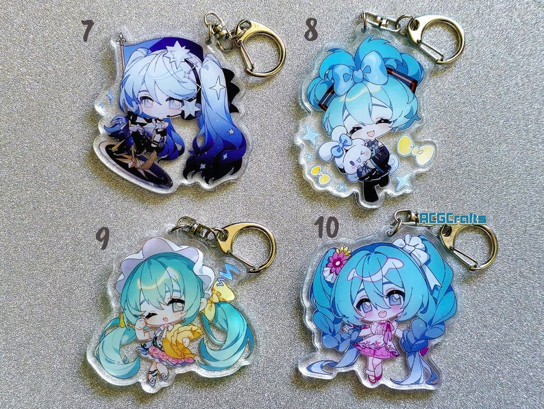 May include: Four clear acrylic keychains with different anime characters. Each keychain features a different character with blue and white hair, wearing colorful outfits. The keychains are numbered 7, 8, 9, and 10.