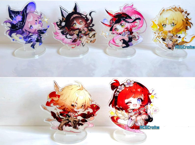 May include: Set of 6 anime character acrylic stands. The stands feature characters with different coloured hair and outfits. The characters are all in a chibi style, with large heads and small bodies. The stands are made of clear acrylic and have a circular base.