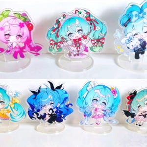 May include: Set of ten acrylic character stands featuring anime-style characters with colorful hair and outfits. The stands are clear and have a circular base.