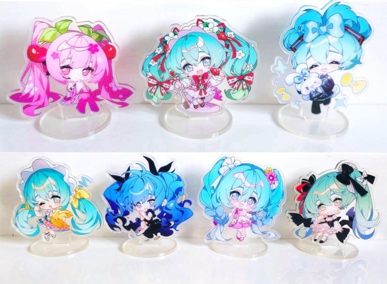 May include: Set of ten acrylic character stands featuring anime-style characters with colorful hair and outfits. The stands are clear and have a circular base.