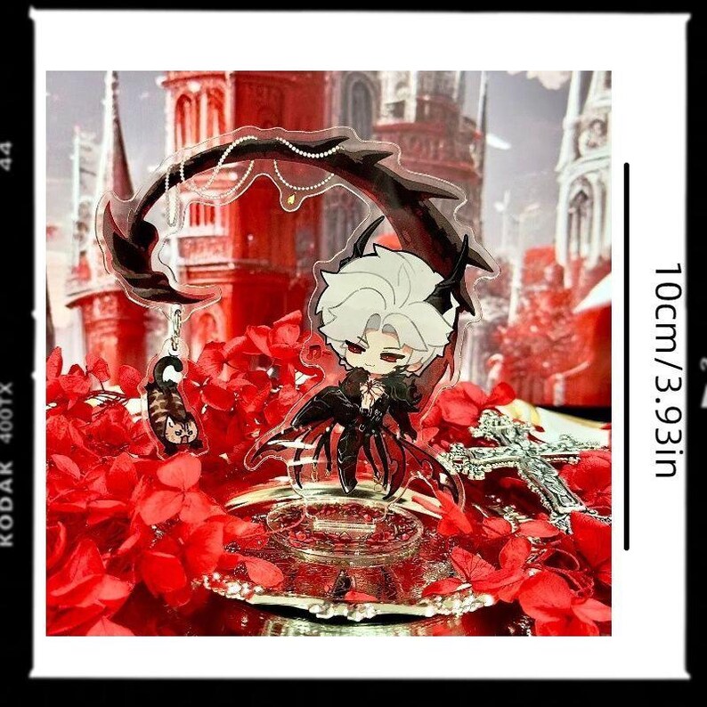 May include: A clear acrylic anime-style figure of a character with white hair and black attire, adorned with a decorative black arch and a small charm. The figure is set against a backdrop of red flowers and a gothic-style building. The figure is 3.93 inches (10cm) tall.