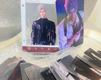 May include: A collection of clear plastic cards featuring illustrations of a man with silver hair. One card is in a red frame with the text "LOVE AND DEEPSPACE" and "Qin Che". The man is wearing a black jacket. Other cards are visible.