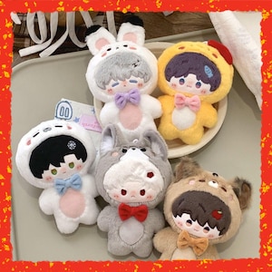 May include: A collection of plush dolls, each dressed in animal-themed costumes. The dolls feature a variety of colors, including white, gray, yellow, and brown. Each doll has a bow tie and a cute facial expression. The dolls are designed to look like a bunny, a wolf, a bear, and a chick.