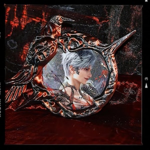 May include: A detailed artistic rendering featuring a portrait within an ornate, bird-shaped frame. The frame is a mix of dark red and bronze, with intricate detailing. The portrait depicts a person with silver hair and delicate facial features, set against a shimmering background.