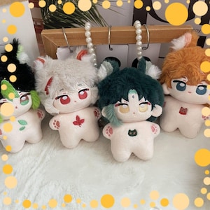 May include: Four plush dolls with anime-style features. Each doll has a unique hair colour, including black, white, green, and orange. The dolls have large eyes, small bodies, and paw-shaped feet. Each doll has a different design on its chest.
