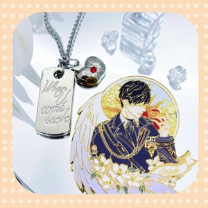 May include: A silver necklace with a dog tag pendant inscribed with "When U come back" and a heart-shaped charm with a red gem. A round enamel pin depicts a male figure with angel wings, holding an apple, and the name "Caleb".