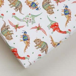 Christmas Wrapping Paper featuring cute Dinos in Christmas Sweaters. Perfect for kids and Dinosaur lovers!
