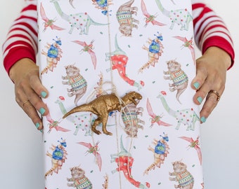 Christmas Wrapping Paper featuring cute Dinos in Christmas Sweaters. Perfect for kids and Dinosaur lovers!
