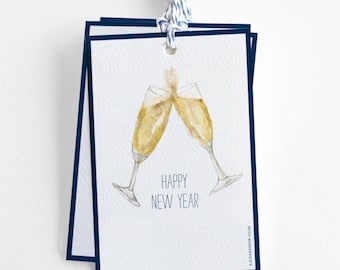 May include: A white card with a navy blue border features a watercolor illustration of two champagne flutes clinking. The text "Happy New Year" is printed below the flutes.