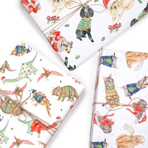 May include: Three different wrapping paper designs featuring holiday-themed animals wearing sweaters. The first design features dinosaurs wearing sweaters, the second features cats wearing sweaters, and the third features dogs wearing sweaters.