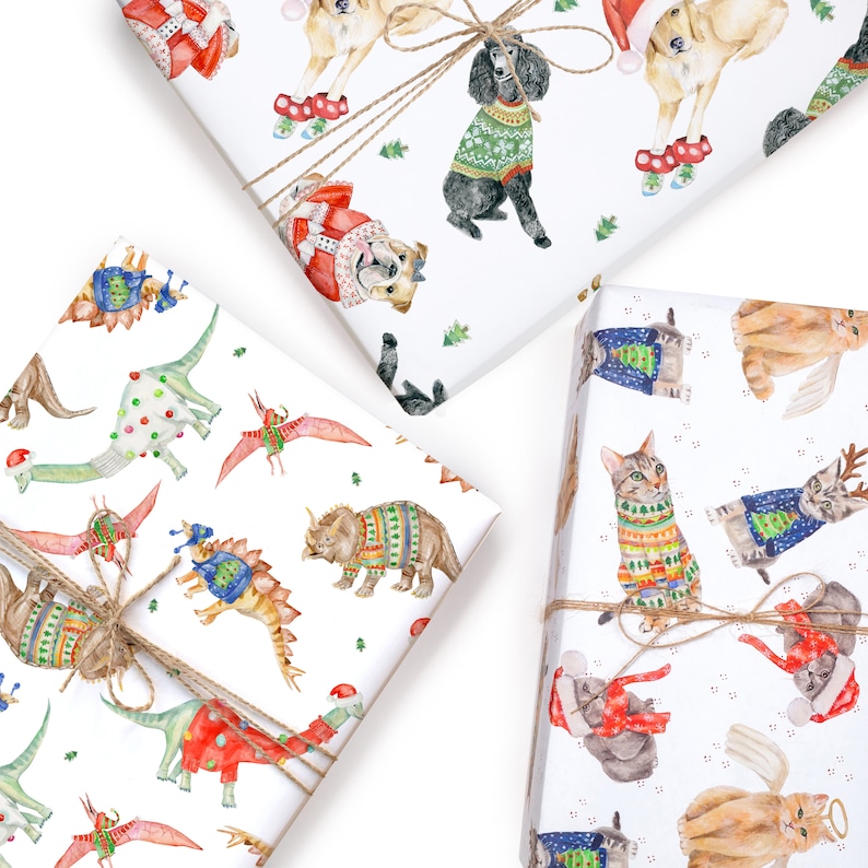 May include: Three different wrapping paper designs featuring holiday-themed animals wearing sweaters. The first design features dinosaurs wearing sweaters, the second features cats wearing sweaters, and the third features dogs wearing sweaters.