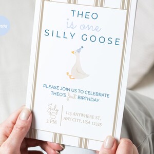 May include: A white and blue birthday invitation with a cartoon goose wearing a party hat. The invitation reads "Theo is one silly goose" and includes the date and time of the party.