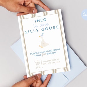 May include: A white and brown striped invitation card with blue text that reads "THEO is one SILLY GOOSE". The card features a cartoon goose wearing a blue party hat. The text also includes the date and time of the event, "July 15, 3 PM", and the address, "123 ANYWHERE ST, ANY CITY, USA 12345".