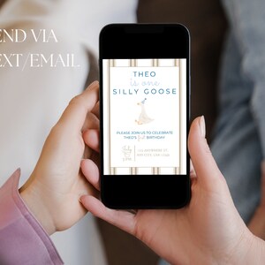 May include: A digital invitation on a smartphone screen for a first birthday party. The invitation features a cartoon goose wearing a party hat and the text "Theo is one Silly Goose". The invitation includes the date, time, and location of the party.
