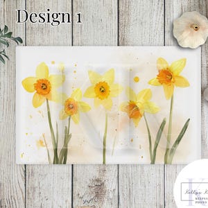 May include: Watercolor painting of yellow daffodils on a white background with subtle watercolor splatters. The painting is on a rectangular canvas and has a light, airy feel.