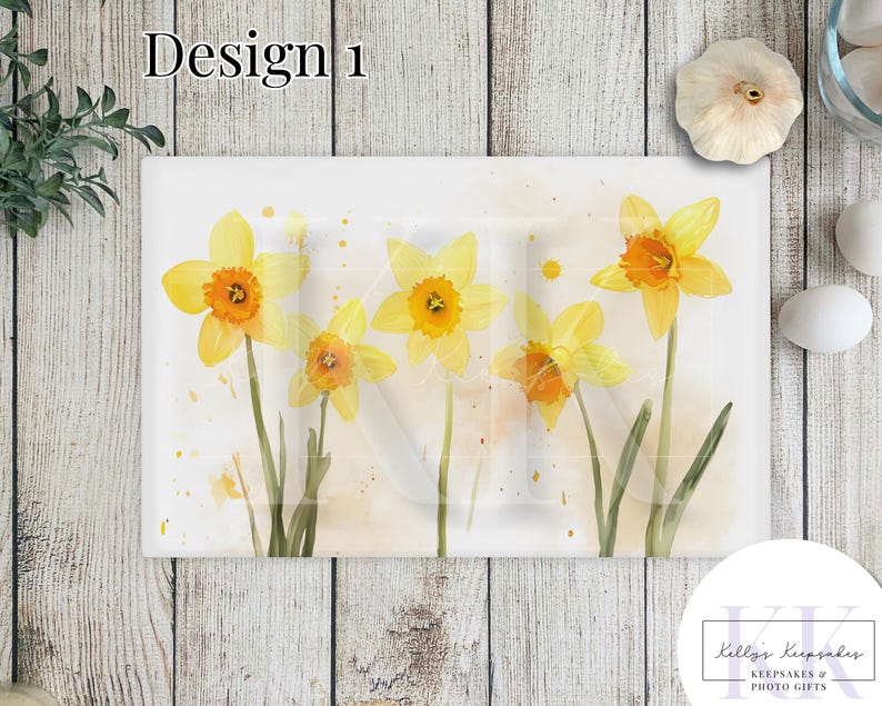 May include: Watercolor painting of yellow daffodils on a white background with subtle watercolor splatters. The painting is on a rectangular canvas and has a light, airy feel.