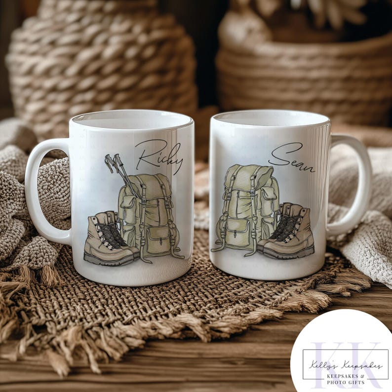 May include: Two white ceramic mugs with handles, each featuring a hiking-themed design. One mug has the name "Ricky" and the other "Sean" in script. The designs include a backpack, hiking boots, and trekking poles.