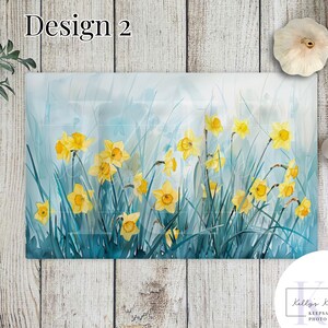 May include: A watercolor painting of yellow daffodils in a field of blue-green grass. The painting has a soft, dreamy feel and is perfect for adding a touch of nature to your home decor.