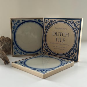 May include: Three blue and white Dutch tile coasters with a decorative border. The coasters are reproductions of a tile from Rotterdam, 18th century. The Metropolitan Museum of Art.