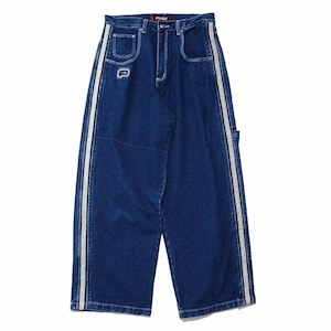 May include: Dark blue denim jeans with white and black side stripes. The jeans have a wide leg design, front pockets, and a small logo patch. The brand name "Plugge" is visible on the waistband.