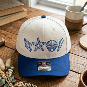 May include: A set of three ceramic mugs with a speckled, matte finish. The mugs are in shades of cream, light gray, and dark gray. Each mug has a simple, minimalist design, perfect for coffee or tea.