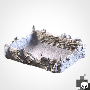 May include: A grey, textured terrain piece for tabletop gaming. The miniature features a cracked surface and jagged, rocky edges, creating a detailed environment for miniature figures. The piece is designed to enhance the visual appeal of role-playing games.