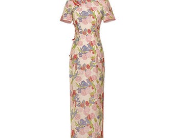 May include: A white dress with a floral print featuring pink, blue, and green flowers. The dress has a mandarin collar and short sleeves.