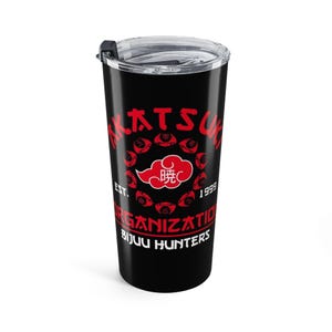 May include: A black stainless steel tumbler with a clear plastic lid. The exterior features red text reading AKATSUKI ORGANIZATION EST. 1999 BIJUU HUNTERS and a central red cloud graphic surrounded by a circular arrangement of small red symbols.