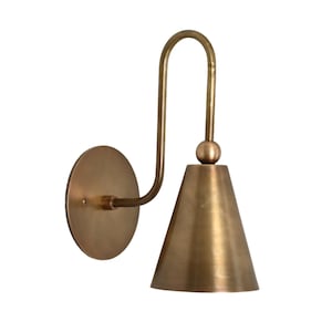 Mid-century modern wall sconces with raw brass finish and Sputnik design, adding style