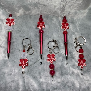 Delta Sigma Theta Sorority beaded pens and keychains. Makes a great gift individually or as a set. Each pen comes with a free ink refill.