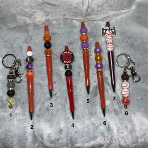 Sports-themed handmade beaded pens and keychains. A nice gift for anyone who loves sports. Free ink refill with pen.