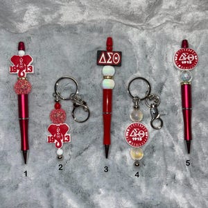 Delta Sigma Theta Sorority Beaded Pens and Keychains. Makes a nice gift for a Delta. Get a free ink refill with each pen.