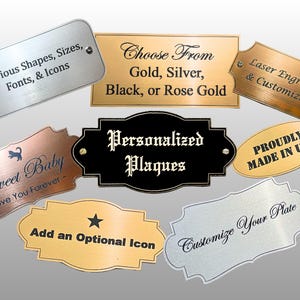 May include: A collection of metal plaques in various shapes and finishes including gold, silver, black, and rose gold. The plaques feature laser-engraved text such as Personalized Plaques, Sweet Baby, and Customize Your Plate, with some including icons.