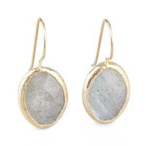 May include: A pair of gold earrings with a round, iridescent labradorite stone set in a textured gold bezel.
