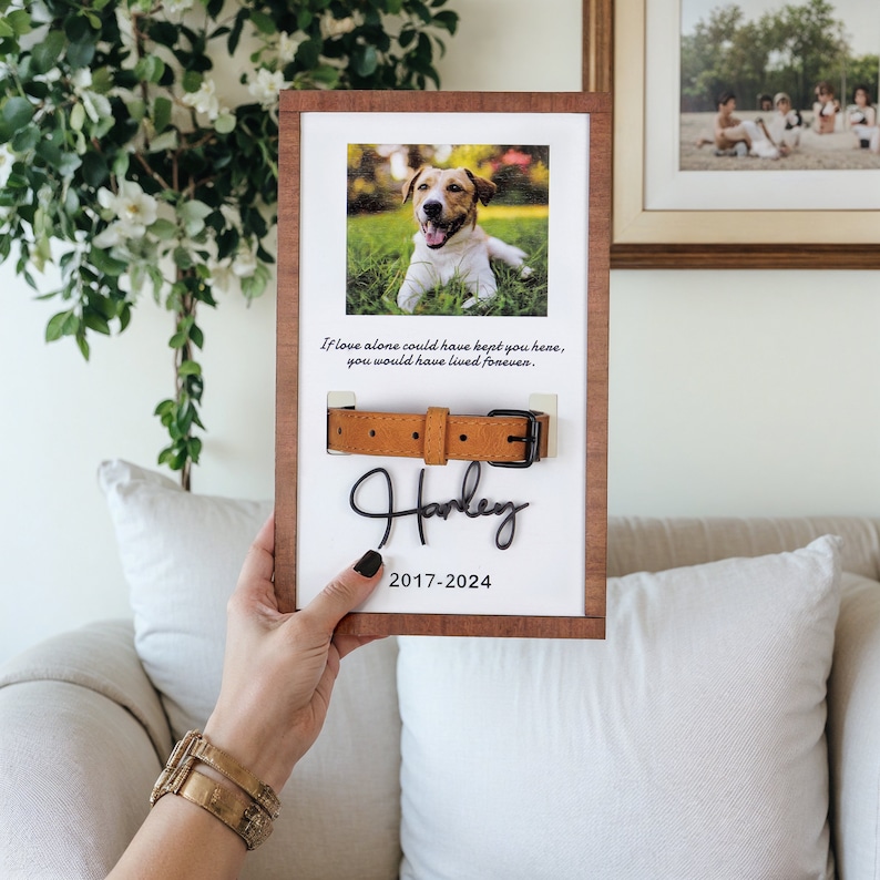 May include: A wooden frame with a photo of a dog, a brown leather collar, and the text "If love alone could have kept you here, you would have lived forever."  The dog's name "Harley" is written in cursive below the collar, along with the dates "2017-2024".