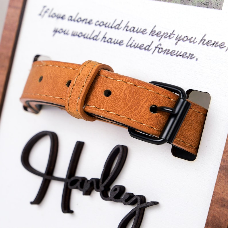 May include: A brown leather dog collar with a black metal buckle. The collar is on a white background with the text "If love alone could have kept you here, you would have lived forever." and the word "Harley" written in black.