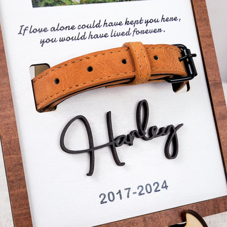 May include: A brown leather dog collar with a black buckle, a wooden plaque with the name "Harley" and the dates "2017-2024" engraved on it, and a quote that reads "If love alone could have kept you here, you would have lived forever."
