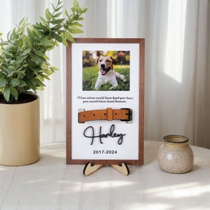 May include: A wooden frame with a photo of a dog, a brown leather collar, and the text "Love alone could have kept you home, you would have lived forever. Harley 2017-2024".