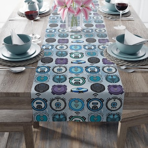 May include: A blue and gray table runner with a repeating pattern of robot vacuum cleaners. The vacuum cleaners are outlined in black and have a blue and white wifi symbol.