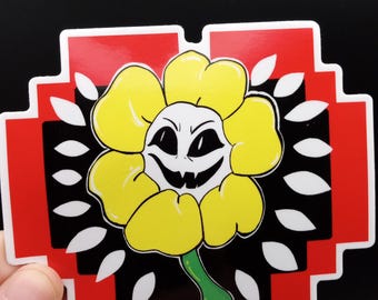 May include: A yellow flower with a black and white face and a sinister grin. The flower is surrounded by white petals and a red and black background.