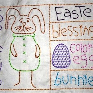 Peut inclure: Tissu blanc brod&eacute; avec un lapin au centre, entour&eacute; des mots "Spring", "Easter blessings", "colored eggs" et "bunnies".