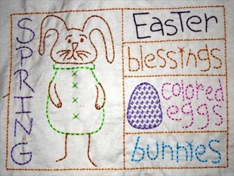 Peut inclure: Tissu blanc brod&eacute; avec un lapin au centre, entour&eacute; des mots "Spring", "Easter blessings", "colored eggs" et "bunnies".