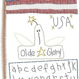 May include: A hand-stitched embroidery design featuring an American flag, a stylized rocket with a star on top, the words "Olde Glory" and "USA", and the alphabet in a rectangular frame.