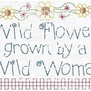 May include: Embroidered design with a floral border and the text "Wild Flowers grown by a Wild Woman". The design is in blue and red thread on a white background.