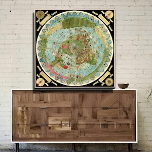 May include: A framed, circular map with a black border, featuring a detailed, colourful illustration of the world. The map is mounted above a wooden dresser with a white frame. A modern chair and a potted plant are also in the room.