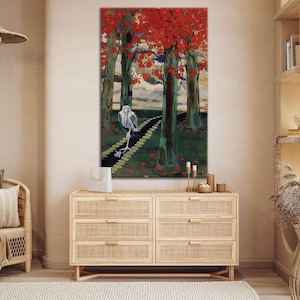 May include: A vertical art print depicts a stylized forest scene. Red leaves adorn the trees, with a path leading through the woods. A white bird walks along the path. The artwork is displayed above a wooden dresser.