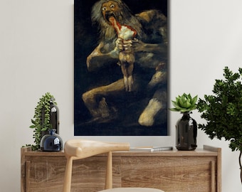 May include: A framed print of Francisco Goya's "Saturn Devouring His Son." The artwork depicts a monstrous figure with wide eyes and an open mouth, consuming a smaller, nude figure. The painting is dark with muted tones.