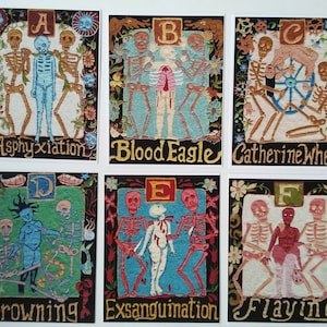 May include: A set of six colorful embroidered cards depicting different methods of execution. Each card features a letter of the alphabet, a gruesome scene, and the name of the method. The cards are framed in black and have a white background.