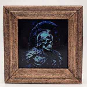May include: Square wooden framed art print featuring a skeletal warrior in a helmet with a blue and teal color scheme. The artwork has a dark background and is framed in a rustic brown wood.
