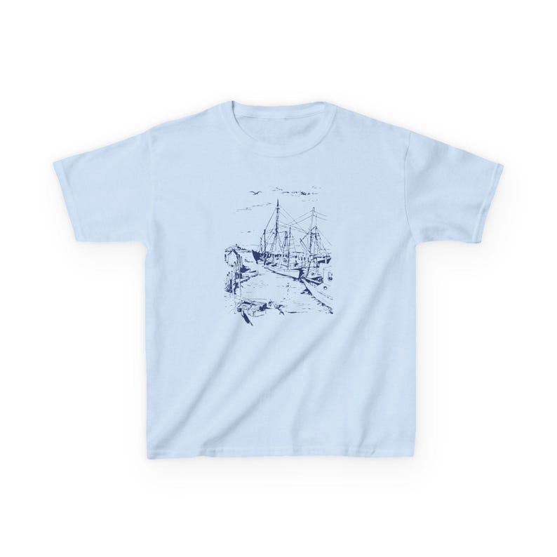 A light blue t-shirt with a navy blue illustration of a ship docked at a pier Sailboats Baby Tee, Seashell Baby Tee, Nautical Baby Tee, Nautical T-Shirt, Ocean Theme Crop Tee, Beach Day Crop Top, Summer Baby Tee